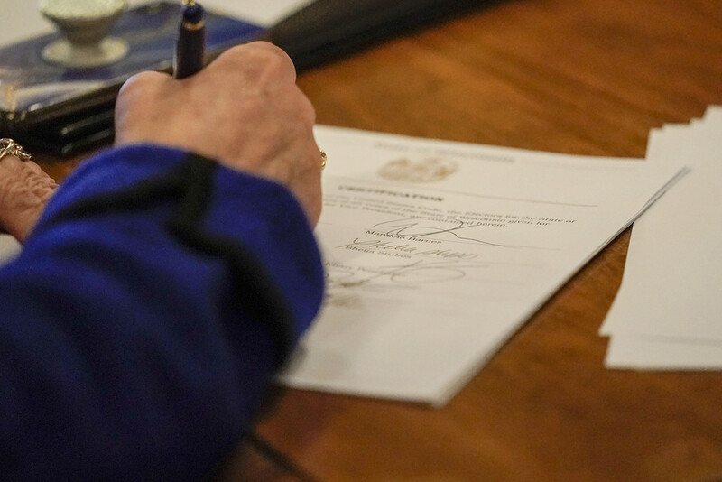 FILE - Members of Wisconsin's Electoral College cast their votes at the state Capitol in Madison, Wis., Monday, Dec. 14, 2020. (AP Photo/Morry Gash, Pool, File)