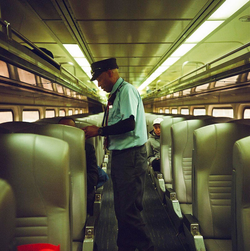 Eric Courtney, an Amtrak conductor, checks passengers’ tickets aboard the Amtrak Hiawatha service Jan. 6, 2025, in Milwaukee. Courtney says he has worked as an Amtrak conductor for 16 years since moving to Wisconsin from Texas. (Photos by Joe Timmerman / Wisconsin Watch)