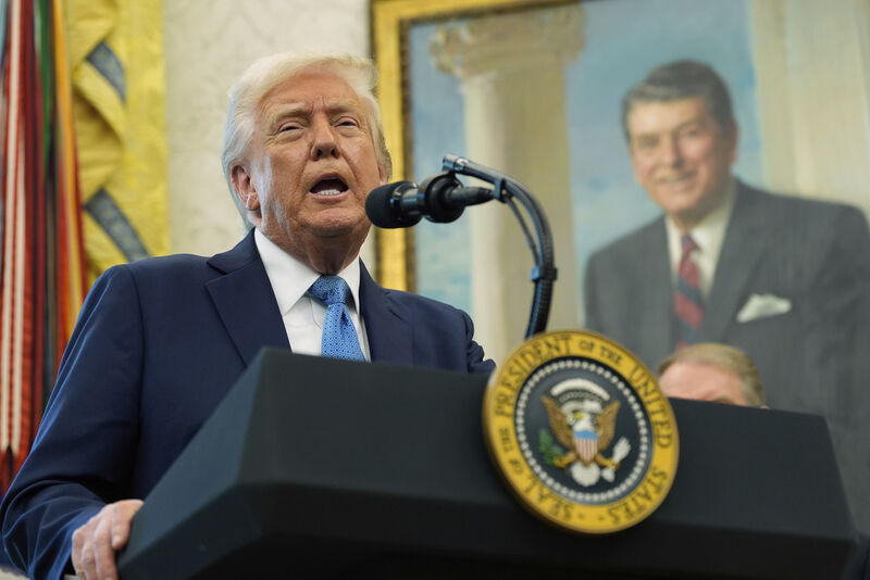 President Donald Trump speaks with reporters as he participates in a ceremonial swearing in of Paul Atkins as chairman of the Securities and Exchange Commission, in the Oval Office of the White House, Tuesday, April 22, 2025, in Washington. (AP Photo/Alex Brandon)