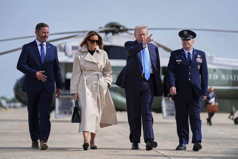 President Donald Trump, escorted by Col. Paul Pawluk, Vice Commander of the 89th Airlift Wing, and first lady Melania Trump, walk to board Air Force One for a trip to attend the funeral of Pope Francis, Friday, April 25, 2025, at Andrews Air Force Base, Md. Derek Rea is left. (AP Photo/Evan Vucci)