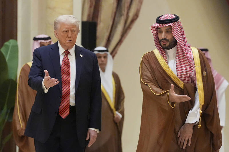 President Donald Trump arrives with Saudi Crown Prince Mohammed bin Salman for the group photo with Gulf Cooperation Council leaders during the GCC Summit in Riyadh, Saudi Arabia, Wednesday, May 14, 2025. (AP Photo/Alex Brandon)