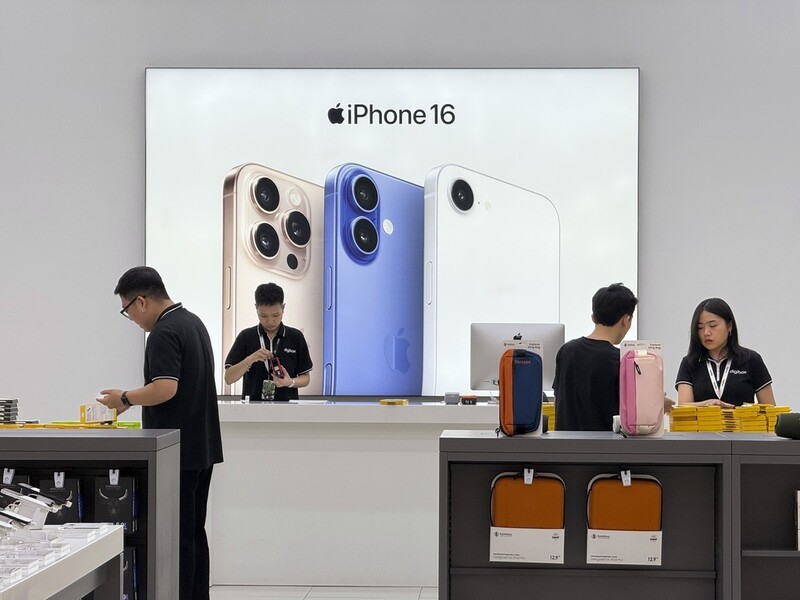 FILE - Sales staffs work at an Apple shop in Hanoi, Vietnam Thursday, April 10, 2025. (AP Photo/Hau Dinh, File)