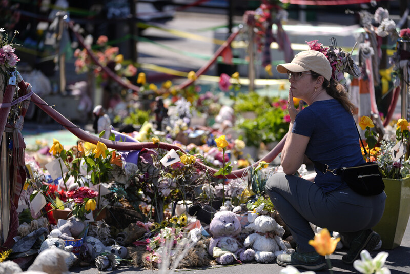 A person visits the spot of George Floyd's murder at George Floyd Square on the five-year anniversary of Floyd's death, Sunday, May 25, 2025, in Minneapolis. (AP Photo/Abbie Parr)