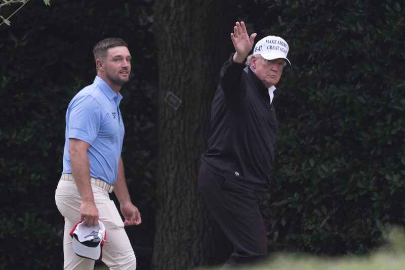 President Donald Trump, right, walks toward the Oval Office as he returns to the White House with Bryson DeChambeau, winner of the 2024 U.S. Open, after playing golf, Sunday, June 1, 2025. (AP Photo/Manuel Balce Ceneta)