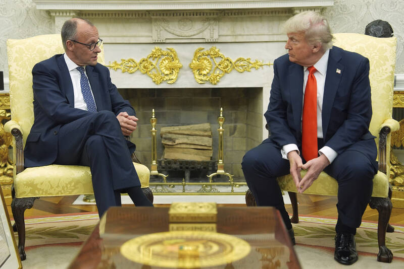 President Donald Trump, right, listens during a meeting with Germany's Chancellor Friedrich Merz in the Oval Office of the White House, Thursday, June 5, 2025, in Washington. (AP Photo/Evan Vucci)