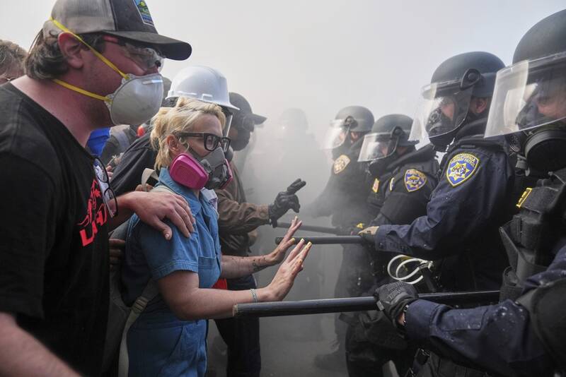 Protesters confront police on the 101 Freeway near the Metropolitan Detention Center of downtown Los Angeles, Sunday, June 8, 2025, following last night's immigration raid protest. (AP Photo/Jae C. Hong)