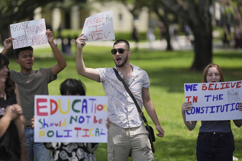 FILE - A group of Florida International University students protest against cuts in federal funding and an agreement by campus police to partner with Immigration and Customs Enforcement, on the FIU campus on a day of protests around the country in support of higher education, April 17, 2025, in Miami. (AP Photo/Rebecca Blackwell, File)