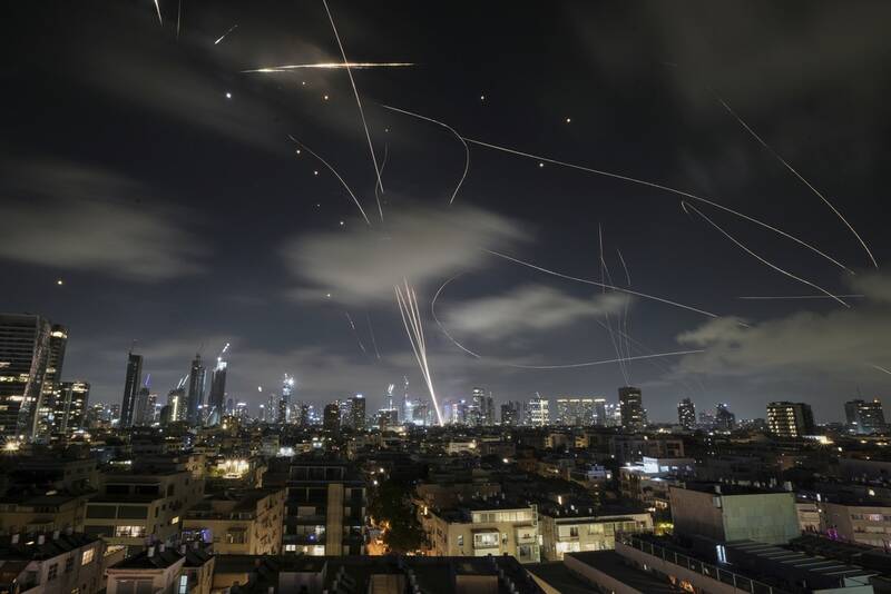 The Israeli Iron Dome air defense system fires to intercept missiles during an Iranian attack over Tel Aviv, Israel, early Wednesday, June 18, 2025. (AP Photo/Leo Correa)