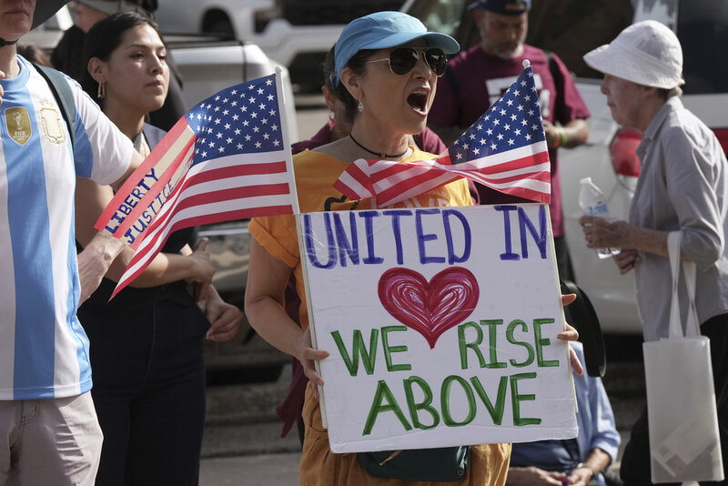 Immigration advocates protest recent detentions by ICE outside the immigration court in San Antonio, Texas, Tuesday, July 1, 2025. (AP Photo/Eric Gay)