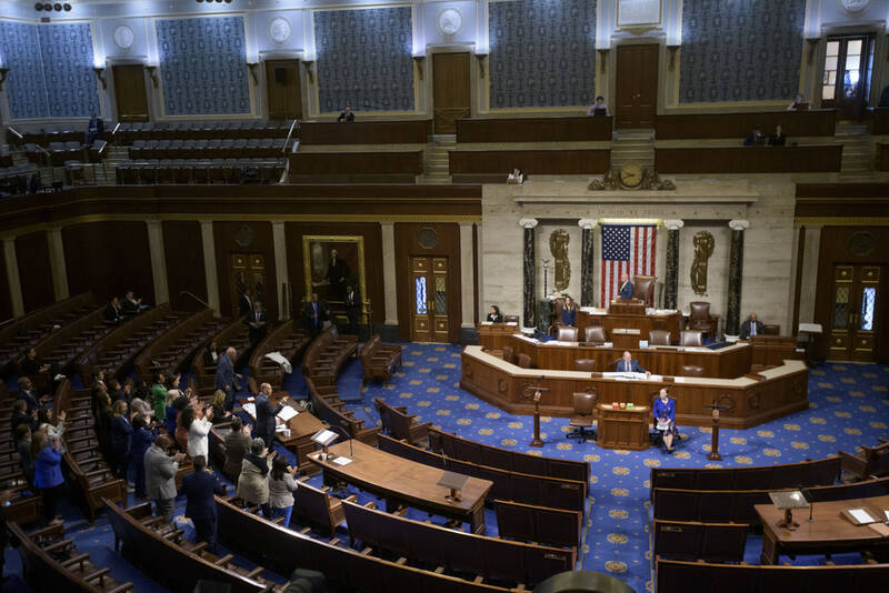 House Minority Leader Hakeem Jeffries, D-N.Y., left, speaks in the House chamber as House Democrats stand to applaud him, prior to the final vote for President Donald Trump's signature bill of tax breaks and spending cuts, at the Capitol, Thursday, July 3, 2025, in Washington. (AP Photo/Rod Lamkey, Jr.)