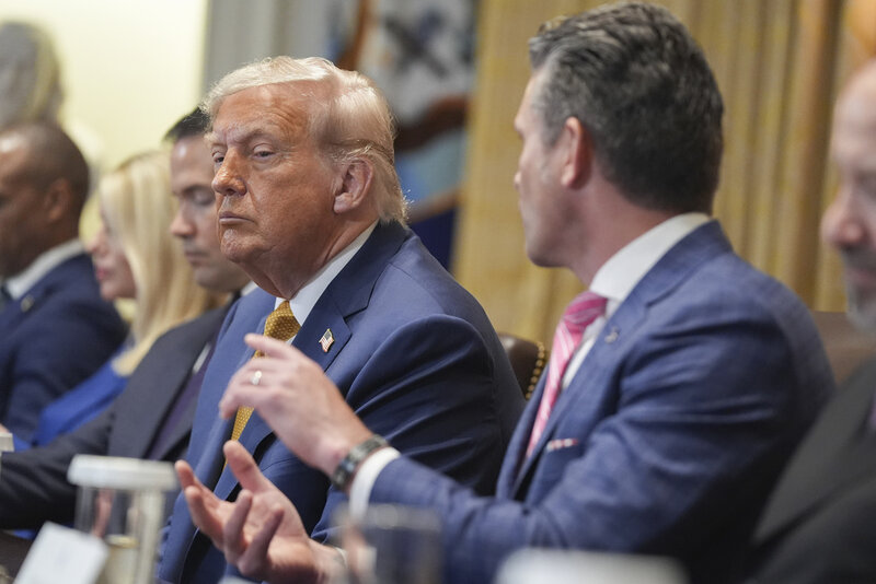 President Donald Trump, left, listens as Secretary of Defense Pete Hegseth, right, speaks during a cabinet meeting at the White House, Tuesday, July 8, 2025, in Washington. (AP Photo/Evan Vucci)
