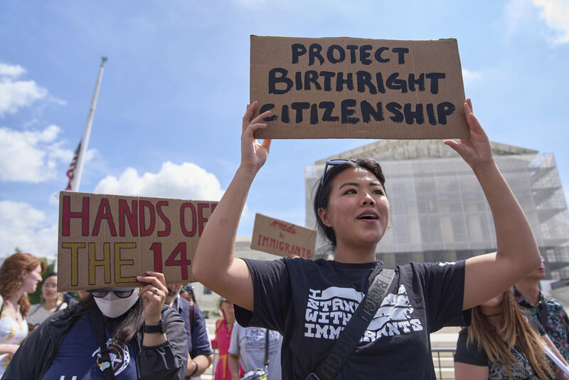 FILE - Hannah Liu, 26, of Washington, holds up a sign in support of birthright citizenship, May 15, 2025, outside of the Supreme Court in Washington. "This is enshrined in the Constitution. My parents are Chinese immigrants," says Liu. "They came here on temporary visas so I derive my citizenship through birthright." (AP Photo/Jacquelyn Martin, File)