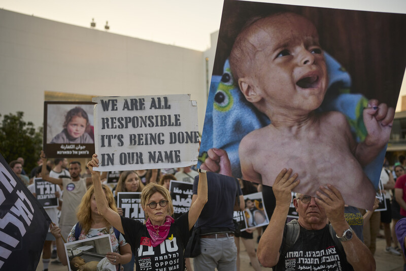 Israeli activists take part in a protest against the war in the Gaza Strip, Israel's measures regarding food distribution and the forced displacement of Palestinians, in Tel Aviv, Israel, Tuesday, July 22, 2025. (AP Photo/Ohad Zwigenberg)
