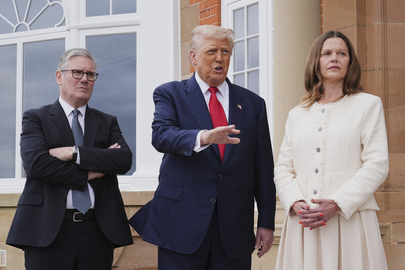 President Donald Trump, center, speaks with the media as he greets Britain's Prime Minister Keir Starmer, left, and his wife Victoria at the Trump Turnberry golf course in Turnberry, Scotland Monday, July 28, 2025. (AP Photo/Jacquelyn Martin)