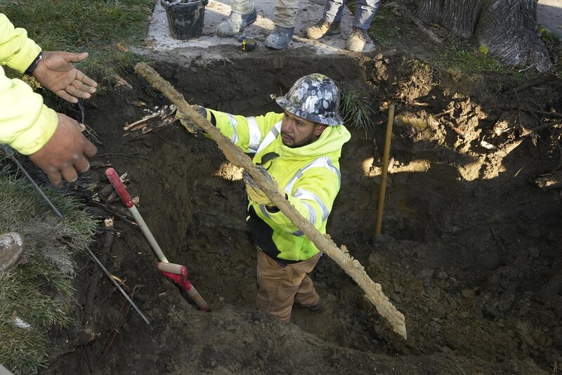 FILE - A cut lead pipe is pulled from a dig site for testing at a home in Royal Oak, Mich., on Nov. 16, 2021. (AP Photo/Carlos Osorio, File)
