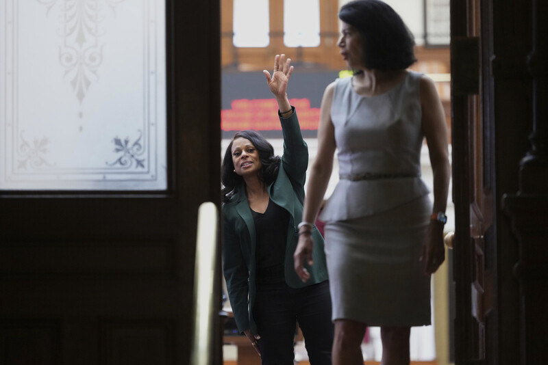Texas state Rep. Nicole Collier, left, waves past Texas state Sen. Carol Alvarado, right, to supporters outside of the House Chamber where she refuses to leave due to a required law enforcement escort, Tuesday, Aug. 19, 2025, in Austin, Texas. (AP Photo/Eric Gay)