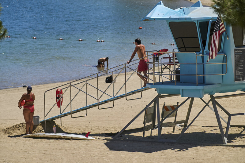 Los Angeles County lifeguards stand on guard as people cool off at Castaic Lake on Wednesday, Aug. 20, 2025, in Castaic, Calif. (AP Photo/Damian Dovarganes)