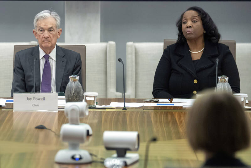 FILE - Federal Reserve Chairman Jerome Powell, and Board of Governors member Lisa Cook, right, listen during an open meeting of the Board of Governors at the Federal Reserve, June 25, 2025, in Washington. (AP Photo/Mark Schiefelbein, File)