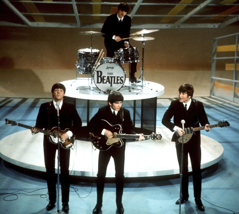 FILE -The Beatles, foreground from left, Paul McCartney, George Harrison, John Lennon and Ringo Starr, on drums, perform on the CBS "Ed Sullivan Show" in New York, Feb. 9, 1964. (AP Photo/File)