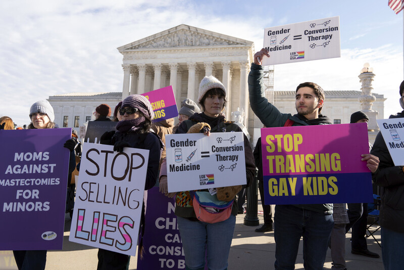 FILE - Demonstrators against transgenders rights protest during a rally outside of the Supreme Court, Dec. 4, 2024, in Washington. (AP Photo/Jose Luis Magana, File)