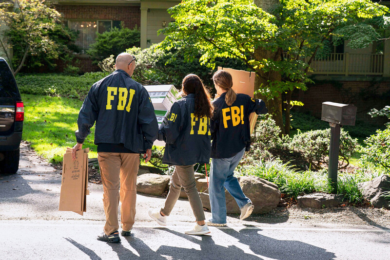 FBI agents carry empty boxes to former national security adviser John Bolton's house, Friday, August. 22, 2025, in Bethesda, Md. (AP Photo/Jose Luis Magana)