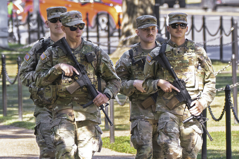 Armed National Guard soldiers walk along Constitution Avenue in Washington during rush hour as part of President Donald Trump's order to impose federal law enforcement in the nation's capital, Tuesday, Aug. 26, 2025. (AP Photo/J. Scott Applewhite)