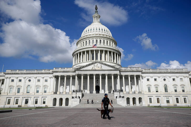 A U.S. Capitol Police officer walks in front of the U.S. Capitol, Aug. 22, 2025, in Washington. (AP Photo/Rahmat Gul)