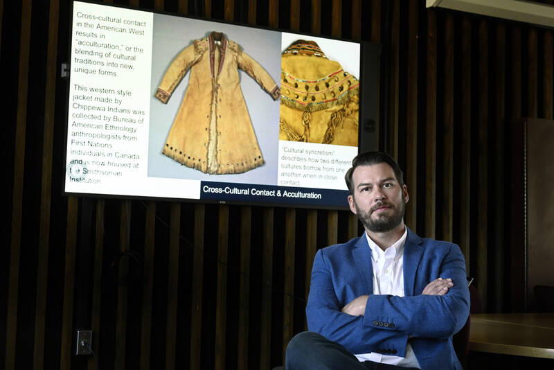 In this Sept. 3, 2025 photo, Samuel J. Redman, Ph.D., Professor of History and Director of the Public History Program at the University of Massachusetts, sits in front of content he uses from the Smithsonian on campus in Amherst, Mass. (AP Photo/Jessica Hill)