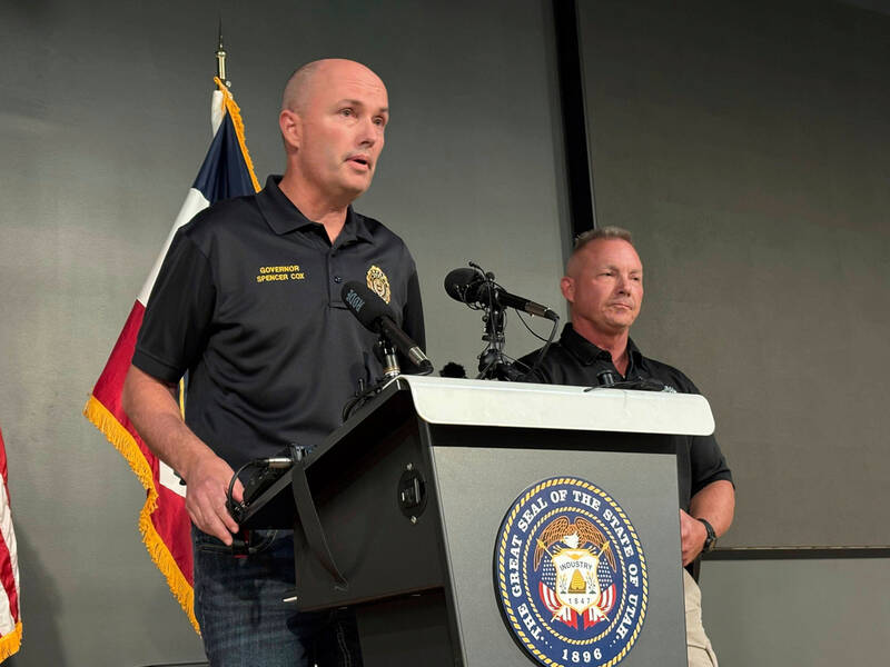 Utah Gov. Spencer Cox, left, speaks with Utah Valley University Chief of Police Jeff Long, right, at a press conference at the Keller Building on the Utah Valley University campus after Charlie Kirk was shot and died during Turning Point's visit to the university, Wednesday, Sept. 10, 2025, in Orem, Utah. (AP Photo/Hannah Schoenbaum)
