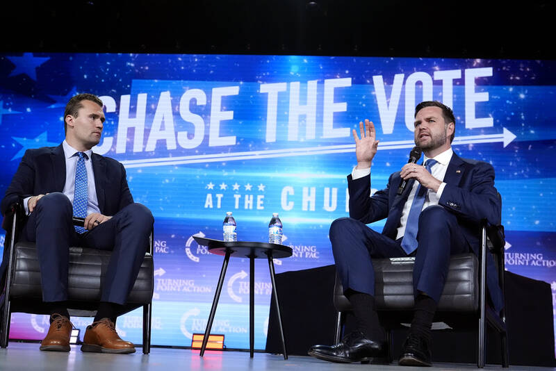 FILE - Republican vice presidential nominee Sen. JD Vance, R-Ohio, right, speaks at a campaign event as Turning Point USA Founder Charlie Kirk, left, listens, Wednesday, Sept. 4, 2024, in Mesa, Ariz. (AP Photo/Ross D. Franklin, File)