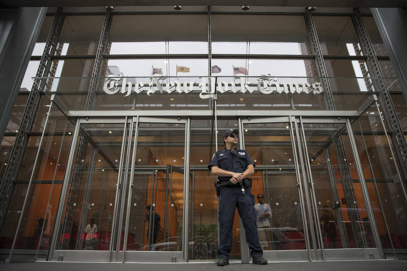 FILE- A police officer stands guard outside The New York Times building in New York, on June 28, 2018. (AP Photo/Mary Altaffer, File)