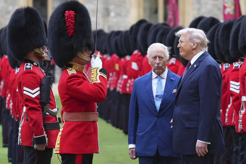 President Donald Trump and Britain's King Charles III review the Guard of Honour after the arrival at Windsor Castle in Windsor, England, Wednesday, Sept. 17, 2025.(AP Photo/Kirsty Wigglesworth, Pool)