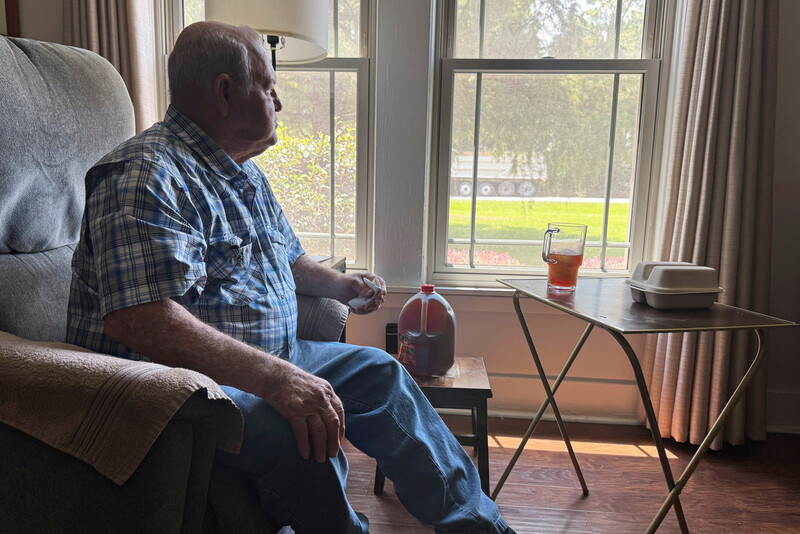 Buddy McCartney watches hundreds of trucks pass by his home in Holly Ridge, La., on their way to what will become Meta's largest data center, Monday, Aug. 18, 2025. (AP Photo/Sophie Bates)