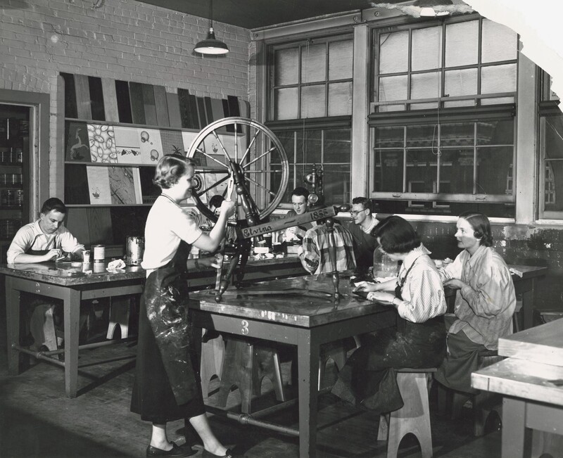 Students restore and refinish an 1855 antique wooden spinning wheel. Photo circa 1953.