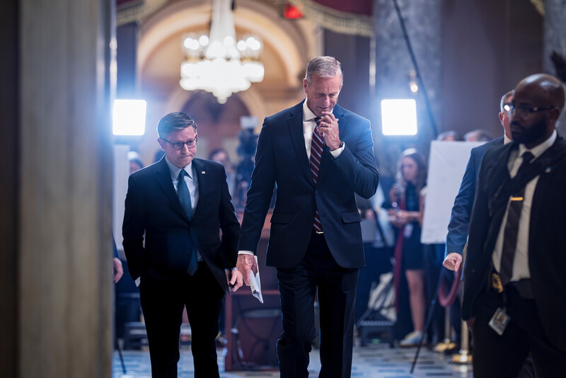 Speaker of the House Mike Johnson, R-La., left, and Senate Majority Leader John Thune, R-S.D., return to their offices after meeting with reporters on the third day of the government shutdown, at the Capitol in Washington, Friday, Oct. 3, 2025. (AP Photo/J. Scott Applewhite)