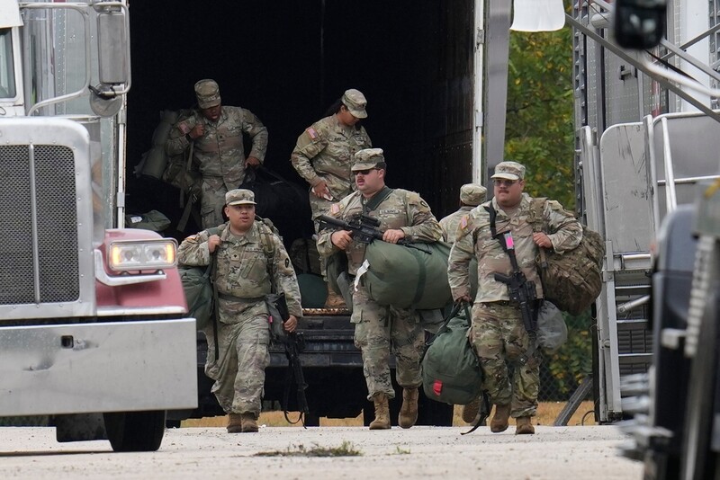 Military personnel in uniform, with the Texas National Guard patch on, are seen at the U.S. Army Reserve Center, Tuesday, Oct. 7, 2025, in Elwood, Ill., a suburb of Chicago. (AP Photo/Erin Hooley)