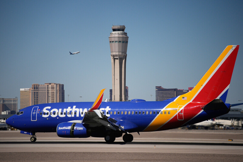 Planes land and take off at Harry Reid International Airport, Tuesday, Oct. 7, 2025, in Las Vegas. (AP Photo/John Locher)