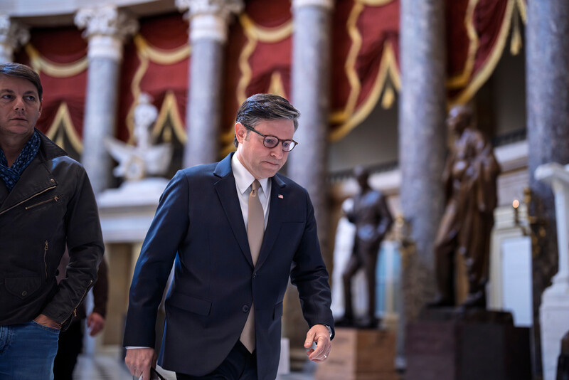 Speaker of the House Mike Johnson, R-La., and Hogan Gidley, left, walking to a press conference as the government shutdown heads toward its third week, at the Capitol in Washington, Monday, Oct. 13, 2025. (AP Photo/J. Scott Applewhite)