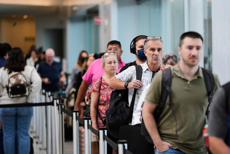 Travelers wait in line for screening at Louis Armstrong New Orleans International Airport in Kenner, La., Wednesday, Oct. 15, 2025. (AP Photo/Gerald Herbert)