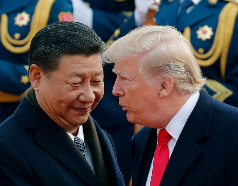 FILE - In this Nov. 9, 2017, file photo, U.S. President Donald Trump, right, chats with Chinese President Xi Jinping during a welcome ceremony at the Great Hall of the People in Beijing. (AP Photo/Andy Wong, File)