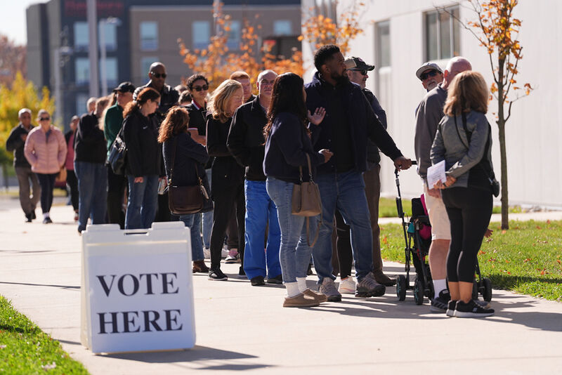 Voters wait in line to cast their ballot at a polling place at Rowan College in Mount Laurel, N.J., Monday, Oct. 27, 2025. (AP Photo/Matt Rourke)