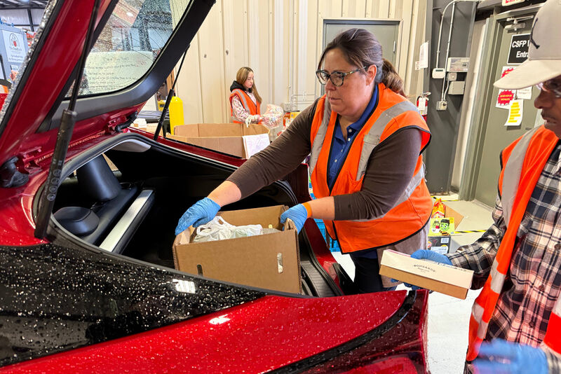 Employees at The Food Bank Inc. load food into a car on Thursday, Oct. 30, 2025 in Dayton, Ohio. (AP Photo/Patrick Aftoora-Orsagos)
