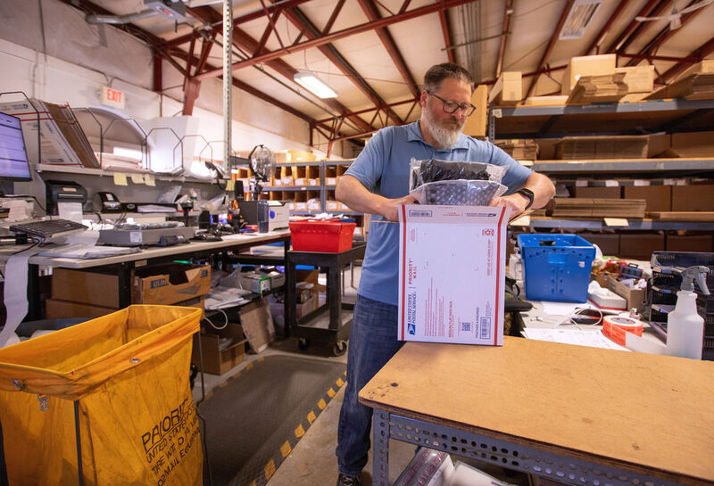 FILE - Terry Precision Cycling warehouse manager Luke Tremble packs orders at the company’s warehouse in Burlington, Vt., Tuesday, Oct. 28, 2025. (AP Photo/Amanda Swinhart, File)