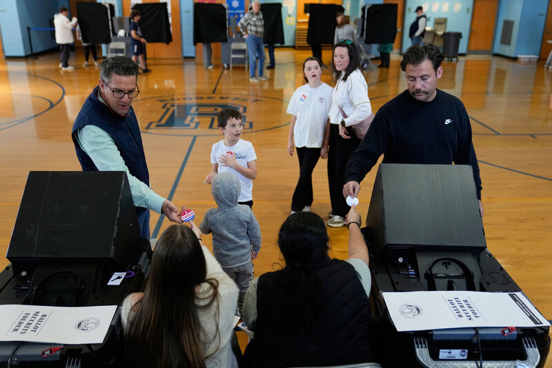 Voters receive stickers after voting at a polling site in River Edge, N.J., Tuesday, Nov. 4, 2025. (AP Photo/Seth Wenig)