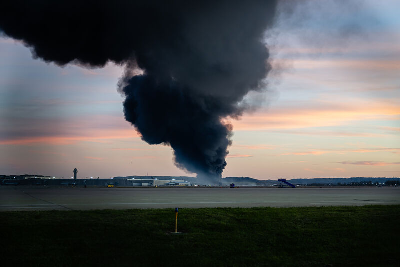 A plume of smoke rises from the site of a UPS cargo plane crash at Louisville Muhammad Ali International Airport on Tuesday, Nov. 4, 2025, in Louisville, Ky. (AP Photo/Jon Cherry)