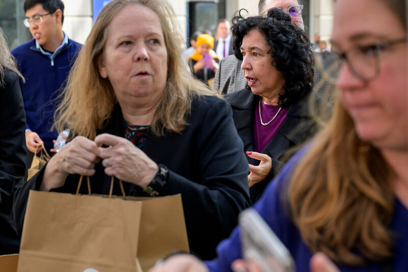 People receive free meals from the World Central Kitchen as they provide food to federal employees and their families near the U.S. Navy Memorial Plaza, during the federal government shutdown, Wednesday, Nov. 5, 2025, in Washington. (AP Photo/Rod Lamkey, Jr.)