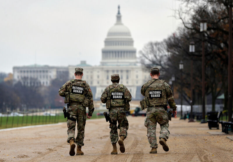 National Guard patrol along the National Mall in front of the Capitol, Wednesday, Nov. 26, 2025, in Washington. (AP Photo/Rahmat Gul)