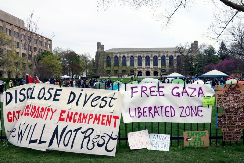 FILE - Signs are displayed outside a tent encampment at Northwestern University on April 26, 2024, in Evanston, Illinois. (AP Photo/Teresa Crawford, file)