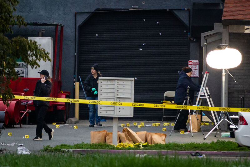 Investigators examine the scene of a mass shooting Sunday, Nov. 30, 2025, in Stockton, Calif. (AP Photo/Ethan Swope)