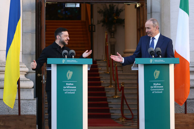 Ukraine's President Volodymyr Zelenskyy, left, and the Irish Prime Minister Micheal Martin gesture to each other as they take part in a joint press conference in Dublin, Ireland, Tuesday, Dec. 2, 2025. (AP Photo/Peter Morrison)